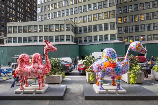 A pair of brightly-colored camel sculptures
