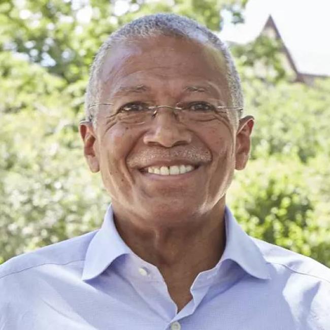 State Senator Robert Jackson smiling outside in front of greenery