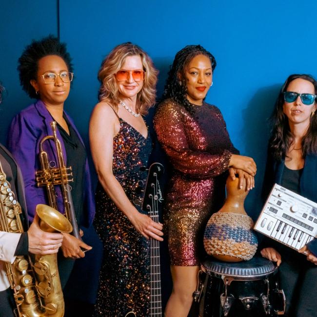 Five women all holding the instruments they play. 